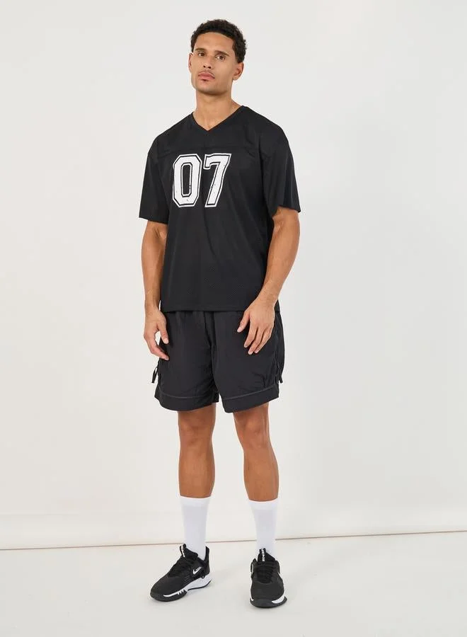 ستايلي اكتيف تيشيرت فضفاض بطبعة فارسيتي وتفاصيل مدروزة